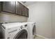 Convenient laundry room with cabinetry, washer, and dryer at 10934 Touchstone Loop, Parker, CO 80134
