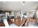 Open concept eat-in kitchen featuring a spacious dining room and living room with a stone fireplace at 10934 Touchstone Loop, Parker, CO 80134