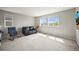 Bright upstairs loft with carpet and natural lighting from two windows at 10934 Touchstone Loop, Parker, CO 80134
