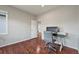 Home office with wood floors, neutral walls, and a view into the hallway at 10934 Touchstone Loop, Parker, CO 80134