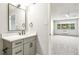 Updated bathroom with a light gray vanity, a modern sink, and an open view to bedroom at 725 S Alton Way # 9C, Denver, CO 80247