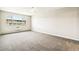 Bright bedroom with neutral carpet, ceiling fan, and large window overlooking the area at 725 S Alton Way # 9C, Denver, CO 80247