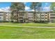 Charming multi-story building with mature trees and well-maintained landscaping and inviting entryway at 725 S Alton Way # 9C, Denver, CO 80247