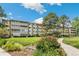 Exterior view of a well-kept multi-story condo building with lush landscaping and sidewalk at 725 S Alton Way # 9C, Denver, CO 80247