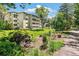Exterior view of a multi-story apartment building with landscaped gardens at 725 S Alton Way # 9C, Denver, CO 80247
