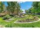 Landscaped gardens with a stone fountain, manicured lawn, and mature shade trees at 725 S Alton Way # 9C, Denver, CO 80247