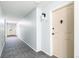 Clean, carpeted hallway with neutral walls and a door with a decorative door knocker at 725 S Alton Way # 9C, Denver, CO 80247