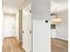 Hallway view with hardwood floors, white trim, and a glimpse of the kitchen beyond at 725 S Alton Way # 9C, Denver, CO 80247