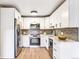 Modern kitchen with white cabinets, stainless steel appliances, and quartz countertops at 725 S Alton Way # 9C, Denver, CO 80247