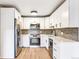 Modern kitchen featuring white cabinets, stainless steel appliances, and a sleek design at 725 S Alton Way # 9C, Denver, CO 80247