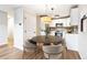 Bright kitchen with stainless appliances, tile backsplash, and pendant lighting over a dining table at 725 S Alton Way # 9C, Denver, CO 80247