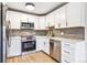 Modern kitchen featuring stainless steel appliances, white shaker cabinets and tiled backsplash at 725 S Alton Way # 9C, Denver, CO 80247