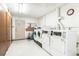 Clean laundry room with modern washers and dryers, tiled floors, and bright lighting at 725 S Alton Way # 9C, Denver, CO 80247