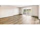 Spacious living room with wood floors and a balcony sliding glass door at 725 S Alton Way # 9C, Denver, CO 80247