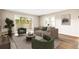 Stylish living room featuring wood floors, cozy seating, and a sliding door to a balcony at 725 S Alton Way # 9C, Denver, CO 80247