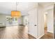 Living room with access to balcony, hardwood floors, and modern overhead light fixture at 725 S Alton Way # 9C, Denver, CO 80247