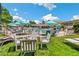 Outdoor swimming pool with lots of lounge chairs, umbrellas, and a manicured lawn at 725 S Alton Way # 9C, Denver, CO 80247