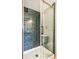 Close-up of a modern glass enclosed shower with stylish blue subway tile and silver hardware at 725 S Alton Way # 9C, Denver, CO 80247