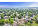 A scenic aerial view of a house in a neighborhood with abundant trees and a sense of community at 8441 S Timberwood St, Highlands Ranch, CO 80126