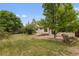 Lush backyard featuring a stone patio and mature trees at 8441 S Timberwood St, Highlands Ranch, CO 80126