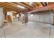 Unfinished basement with concrete floor, wooden beams, and utility systems at 8441 S Timberwood St, Highlands Ranch, CO 80126
