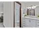 Bathroom with updated white cabinets, marble countertop and walk-in shower at 8441 S Timberwood St, Highlands Ranch, CO 80126
