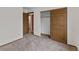 Bright bedroom featuring neutral carpet, closet and an en-suite bathroom at 8441 S Timberwood St, Highlands Ranch, CO 80126