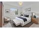 Well-lit bedroom with modern decor, upholstered headboard, bench, and carpeting at 8441 S Timberwood St, Highlands Ranch, CO 80126