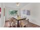 Bright dining area with modern furniture, hardwood floors, and natural light from a large window at 8441 S Timberwood St, Highlands Ranch, CO 80126