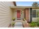 Inviting front entrance with a charming red door, brick accents, and well-maintained landscaping at 8441 S Timberwood St, Highlands Ranch, CO 80126