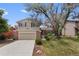 Charming home featuring a brick facade, an attached two-car garage, mature trees and a well-manicured lawn at 8441 S Timberwood St, Highlands Ranch, CO 80126