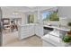 Updated kitchen featuring white cabinets, stainless appliances, and ample countertop space for meal preparation and serving at 8441 S Timberwood St, Highlands Ranch, CO 80126