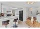 Open-concept kitchen with stainless steel appliances, island with seating, and seamless transition to the dining area at 8441 S Timberwood St, Highlands Ranch, CO 80126