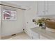 Functional laundry room features a window, storage, and tiled floor for easy cleaning at 8441 S Timberwood St, Highlands Ranch, CO 80126