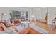 Bright living room with large windows, hardwood floors, and stylish contemporary furnishings at 8441 S Timberwood St, Highlands Ranch, CO 80126