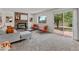 Cozy living room with brick fireplace, plush seating, and sliding glass doors to the backyard and patio area at 8441 S Timberwood St, Highlands Ranch, CO 80126