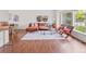 Cozy living area featuring hardwood floors, a comfortable sectional sofa, and ample natural light at 8441 S Timberwood St, Highlands Ranch, CO 80126