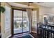 View of the backyard from the kitchen area featuring a patio and mature landscaping at 8293 S Reed St, Littleton, CO 80128