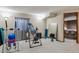 Home gym area with inversion table and exercise equipment, next to bedroom area at 8293 S Reed St, Littleton, CO 80128