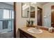 Well-lit bathroom featuring a shower, updated vanity, and decorative plants at 8293 S Reed St, Littleton, CO 80128