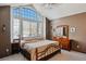 Spacious bedroom with vaulted ceiling, arch window, and natural light at 8293 S Reed St, Littleton, CO 80128