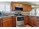 Well-lit kitchen with stainless steel appliances and updated countertops at 8293 S Reed St, Littleton, CO 80128