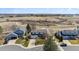 An aerial view of houses along the street near an open field under a bright and sunny sky at 5667 W 109Th Cir, Westminster, CO 80020