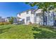 A home's back yard features a lawn, a patio with table and chairs, and a large window overlooking the area at 5667 W 109Th Cir, Westminster, CO 80020