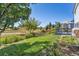 Lush backyard with a sprawling lawn, patio and mature landscaping at 5667 W 109Th Cir, Westminster, CO 80020