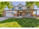 Charming two-story home featuring a well-manicured lawn and inviting front porch perfect for enjoying the outdoors at 5667 W 109Th Cir, Westminster, CO 80020