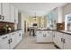 Spacious kitchen with white cabinets, granite countertops, stainless appliances, and open floor plan at 5667 W 109Th Cir, Westminster, CO 80020