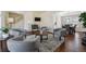 Open-concept living room with hardwood floors, light walls, arched entryways, and open to the dining room and kitchen at 5667 W 109Th Cir, Westminster, CO 80020