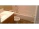 A compact bathroom with a wood vanity, toilet, and a tub with a shower at 10762 E Exposition Ave. Ave # 137, Aurora, CO 80012