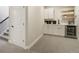 Finished basement with kitchenette featuring new cabinets, flooring, and countertops at 16277 Talons Bluff Ln, Monument, CO 80132